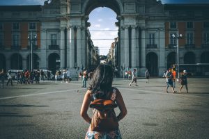Woman visiting Lisbon. People from behind.