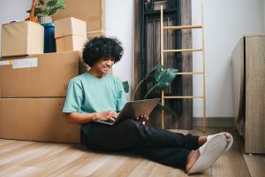 Young Man Checking List of Goods to Move to New House