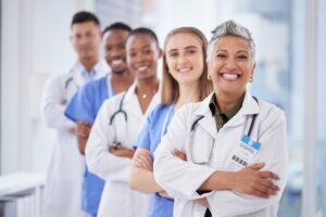 Doctors team, arms crossed and portrait at clinic with happiness, diversity or solidarity for healt