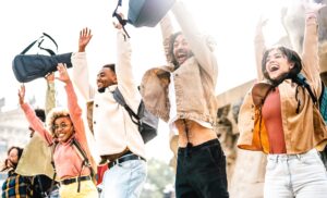 International students jumping and cheering by the end of school at Barcelona city center