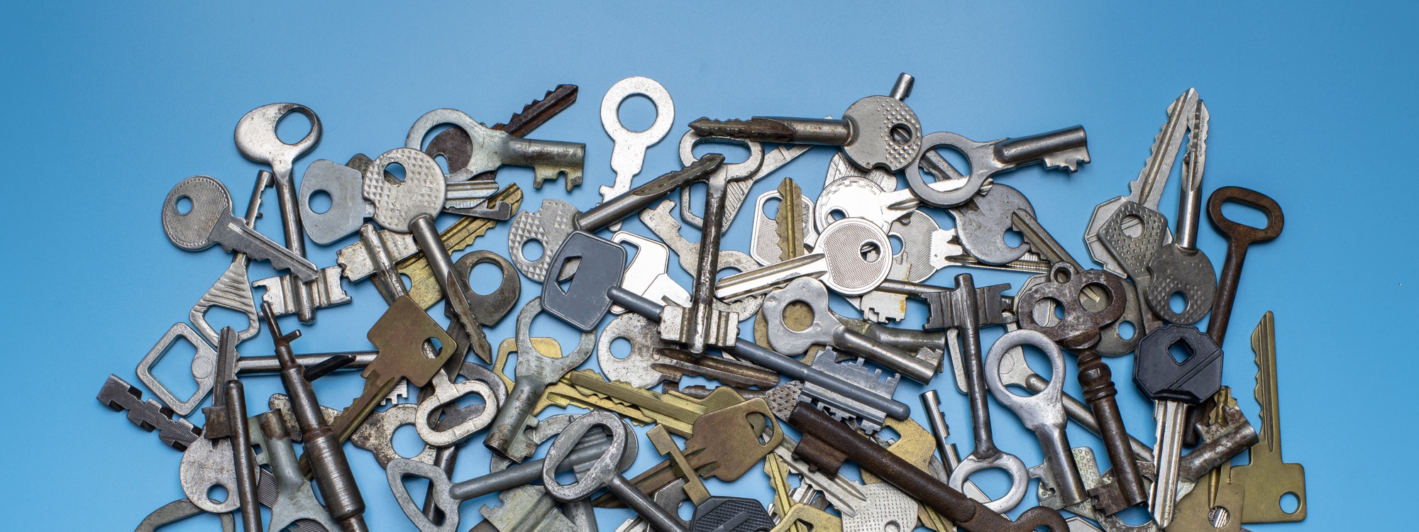 Keys set on blue background. Door lock keys and safes for property security and house protection